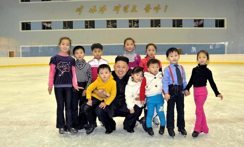 The respected Comrade Kim Jong Un posing for a photograph with children at the People’s Open-air Ice Rink (November 2012)