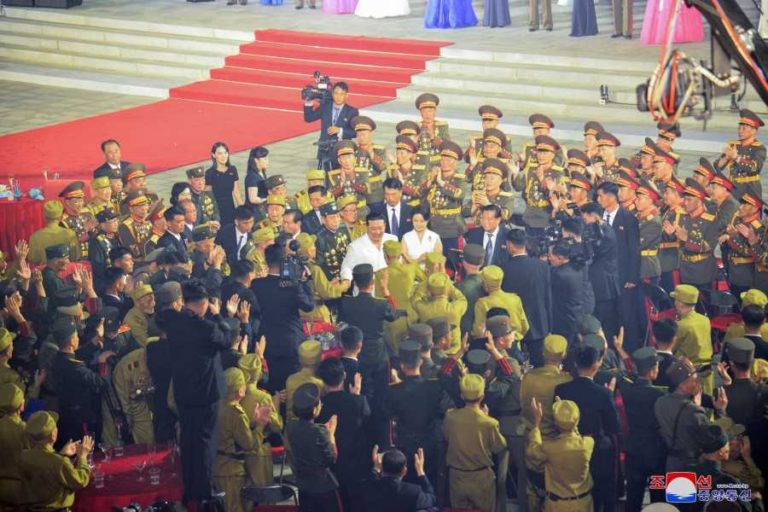 Kim Jong Un warmly shaking hands of the war veterans